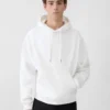 Le sweat-shirt Torsade Sweat à capuche avec logo floqué Le sweat-shirt Torsade Sweat à capuche avec logo floqué